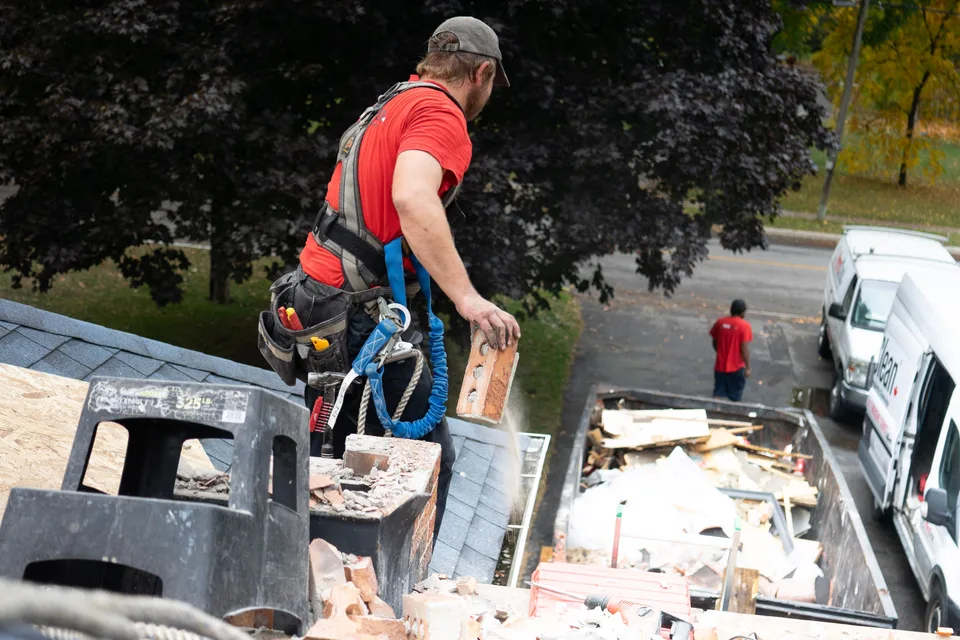 Roofing professional inspecting a roof in Trenton, New Jersey